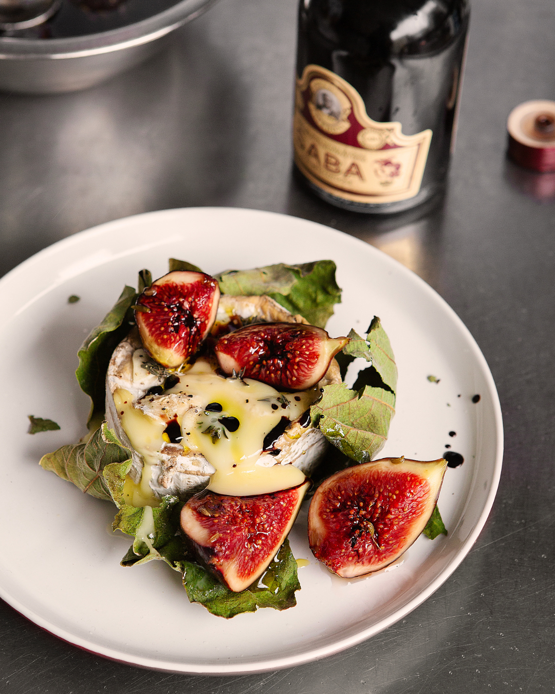Fig Leaf Baked Cheese with Pickled Figs and Saba